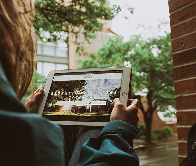 Student using course catalog software on a laptop.